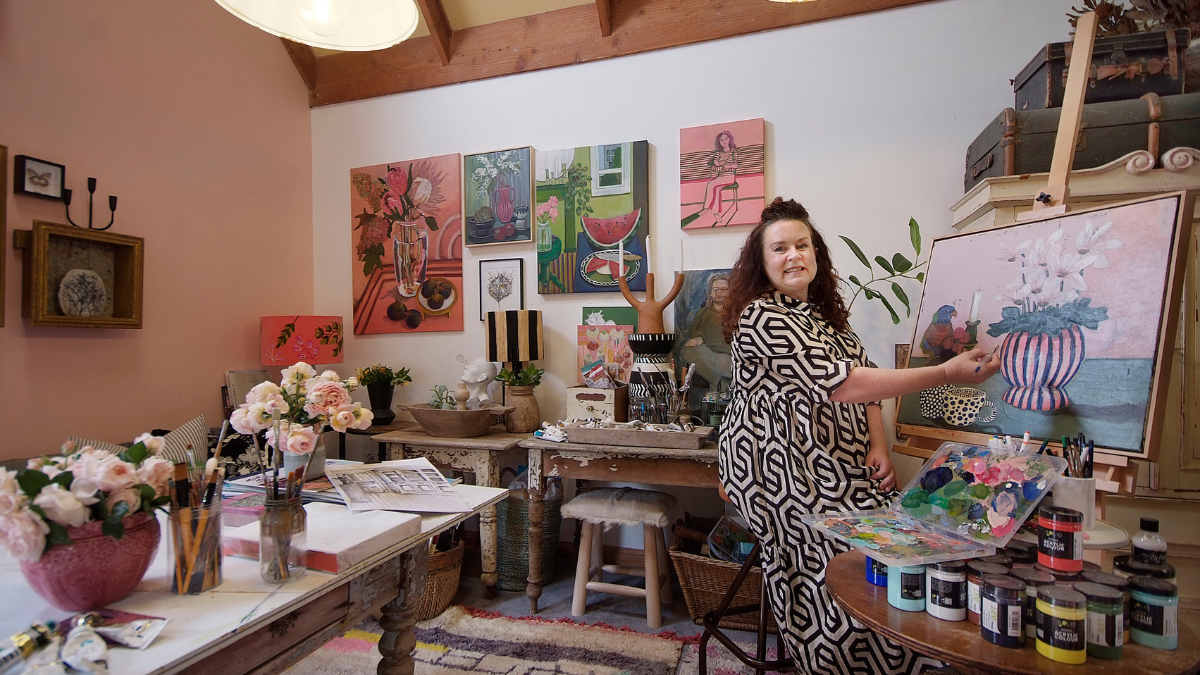 Woman painting in art room pink, white and beige